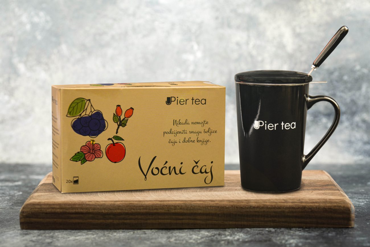 A glass cup of hot tea on a wooden cutting board . High quality photo